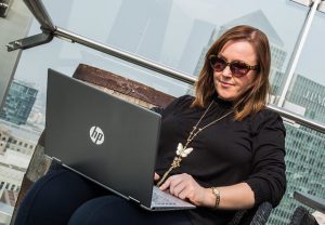 Manuela-Willbold-working-on-laptop-writing-blog-articles-in-London